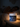 Jar of Aribella Moonlit Magnesium Cream on a bedside table with a person lying in bed in the background